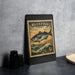 A framed postage stamp featuring a bluefish illustration, placed on a dark surface next to some black camera lenses.