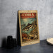 a vintage-style metal stamp with a fish illustration, placed on a table next to some black camera lenses.