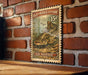 A vintage-style postage stamp featuring a catfish, mounted on a brick wall.