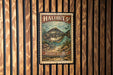 A framed image of a halibut fish, with the text "HALIBUT 5¢" and "ATLANTIC HALIBUT" printed on it, is displayed on a wooden wall.