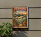 A vintage-style metal sign featuring a King Mackerel fish, mounted on a wall next to a plant.
