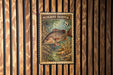 A postage stamp featuring a fish, specifically a Mangrove Snapper, against a wooden background.