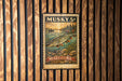 A vintage musky stamp with a fish illustration is displayed on a wooden wall.