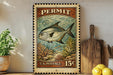 A vintage-style U.S. postage stamp featuring a fish on a coral reef, with a price of 15 cents.