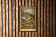 A U.S. postage stamp featuring a pumpkinseed sunfish, which is a type of sunfish. The stamp is displayed on a wooden surface with vertical slats.