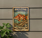 A vintage Rockfish postage stamp is displayed on a wall, featuring a colorful illustration of a rockfish swimming in the ocean.