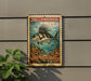 A 20c roosterfish stamp is displayed on a wall, featuring an illustration of a roosterfish swimming in the ocean.