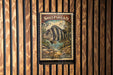 A 5-cent US postage stamp featuring a striped fish, placed on a wooden surface.