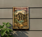 A metal sign with a stamp-like design, featuring a striped fish and a coastal landscape, mounted on a wall.