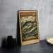 A metal stamp featuring a fish, likely a Skipjack tuna, with a wave and clouds in the background.