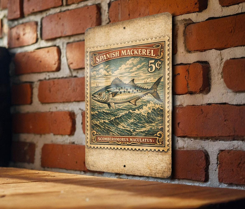 a Spanish Mackerel stamp with a fish illustration, mounted on a brick wall.