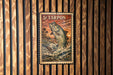 A framed image of a fish, likely a Tarpon, is displayed on a wooden wall.