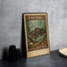 A vintage Tautog postage stamp from the United States, featuring a blackfish illustration, is displayed on a table.