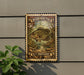 A vintage-style postage stamp featuring a fish, mounted on a wall next to a plant.