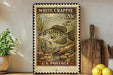 A vintage-style postage stamp featuring a white crappie fish, with the text "WHITE CRAppie 20c" and "U.S. POSTAGE" printed on it. The stamp is displayed on a wall, with a wooden cutting board and a potted plant visible in the foreground.
