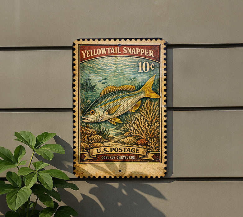 A vintage-style postage stamp featuring a yellowtail snapper fish, mounted on a wall next to a plant.