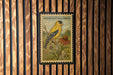 A postage stamp featuring an American Goldfinch, with a vibrant illustration of the bird perched on a branch and a flower nearby.