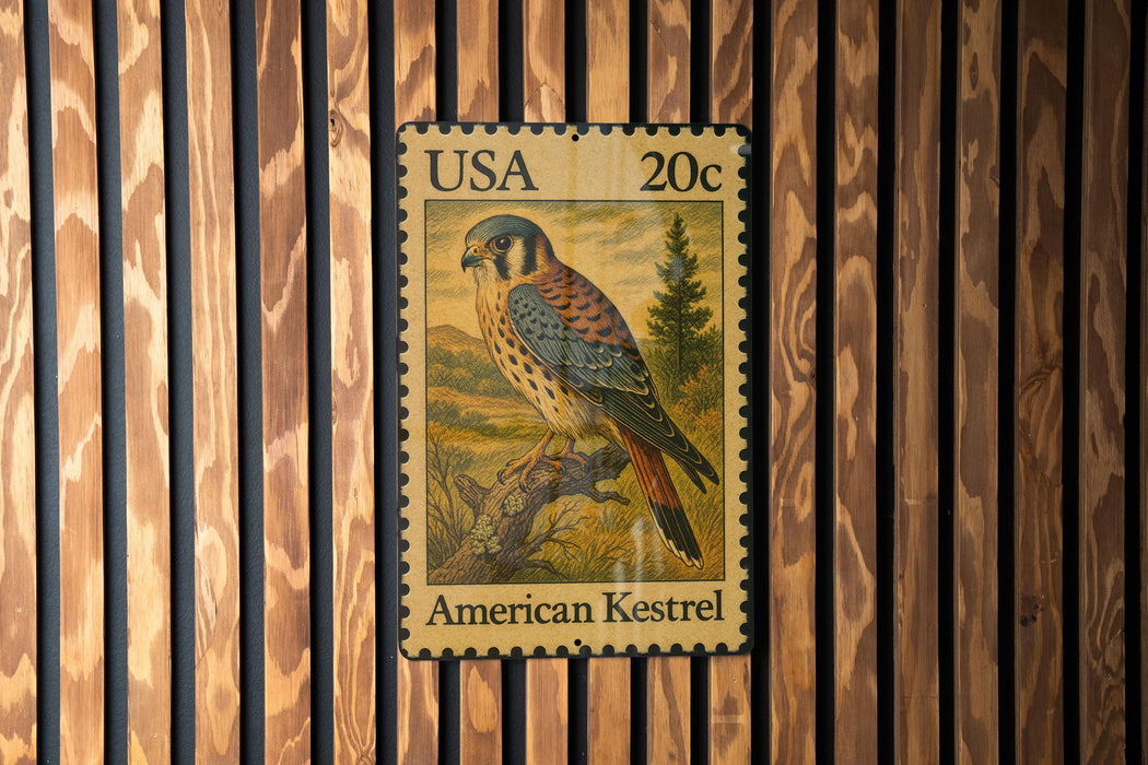 A 20c US postage stamp featuring an American Kestrel bird is displayed on a wooden wall.