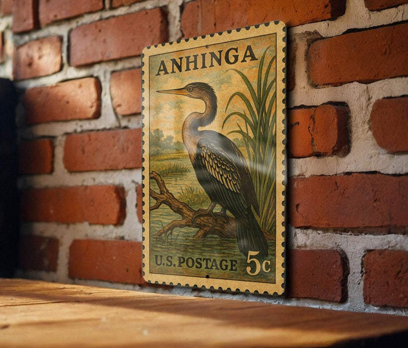 A vintage postage stamp featuring a large bird, likely a heron, perched on a branch against a brick wall.
