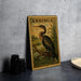 A vintage postage stamp from Anhinga, featuring a large heron, is displayed on a table next to some black camera lenses.