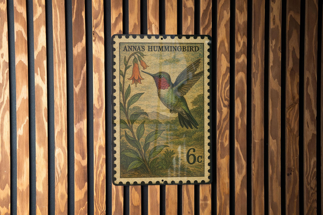A vintage postage stamp featuring a colorful illustration of a hummingbird perched on a flower, set against a wooden background.