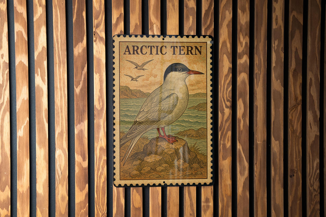 A postage stamp featuring an illustration of an Arctic tern, a bird known for its long legs and distinctive appearance, is displayed on a wooden wall.
