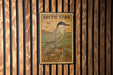 A postage stamp featuring an illustration of an Arctic tern, a bird known for its long legs and distinctive appearance, is displayed on a wooden wall.