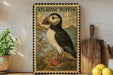 A framed illustration of an Atlantic puffin, a type of bird, is displayed on a shelf next to a wooden cutting board and some lemons.