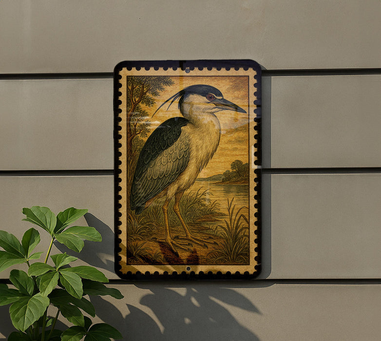 a framed painting of a heron standing on a grassy area, with a plant to the left of the frame.