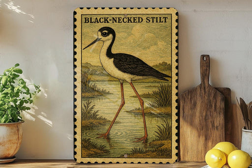 a framed illustration of a black-necked stilt standing on a pond, surrounded by a lush green landscape.