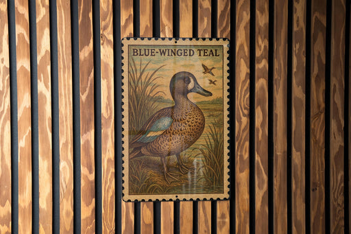 A postage stamp featuring a blue-winged teal duck, which is a type of waterfowl. The stamp is mounted on a wooden wall with vertical slats.
