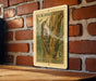 A U.S. postage stamp featuring a brown creeper, a type of tree, is displayed on a brick wall.