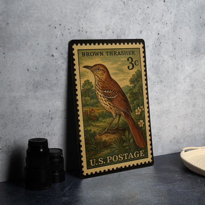 A vintage brown thrasher postage stamp from the United States, featuring a detailed illustration of a brown bird perched on a rock.