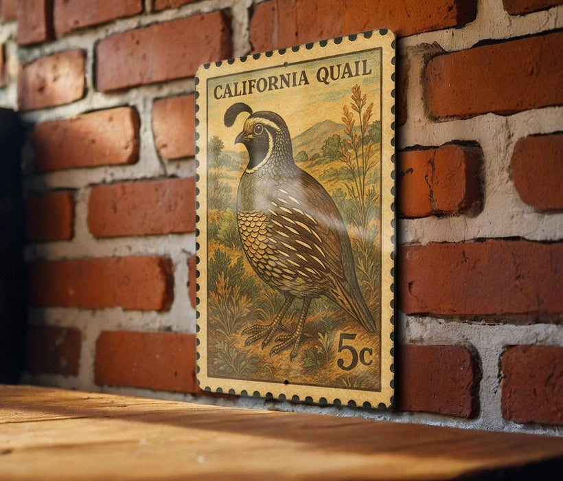A California Quail postage stamp is displayed on a brick wall, with a wooden table below it.