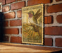 A vintage postage stamp featuring a colorful illustration of a hummingbird is displayed on a brick wall.