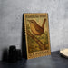 A vintage postage stamp featuring a brown bird perched on a branch, with the text "CAROLINA WREN" and "U.S. POSTAGE" printed on it.