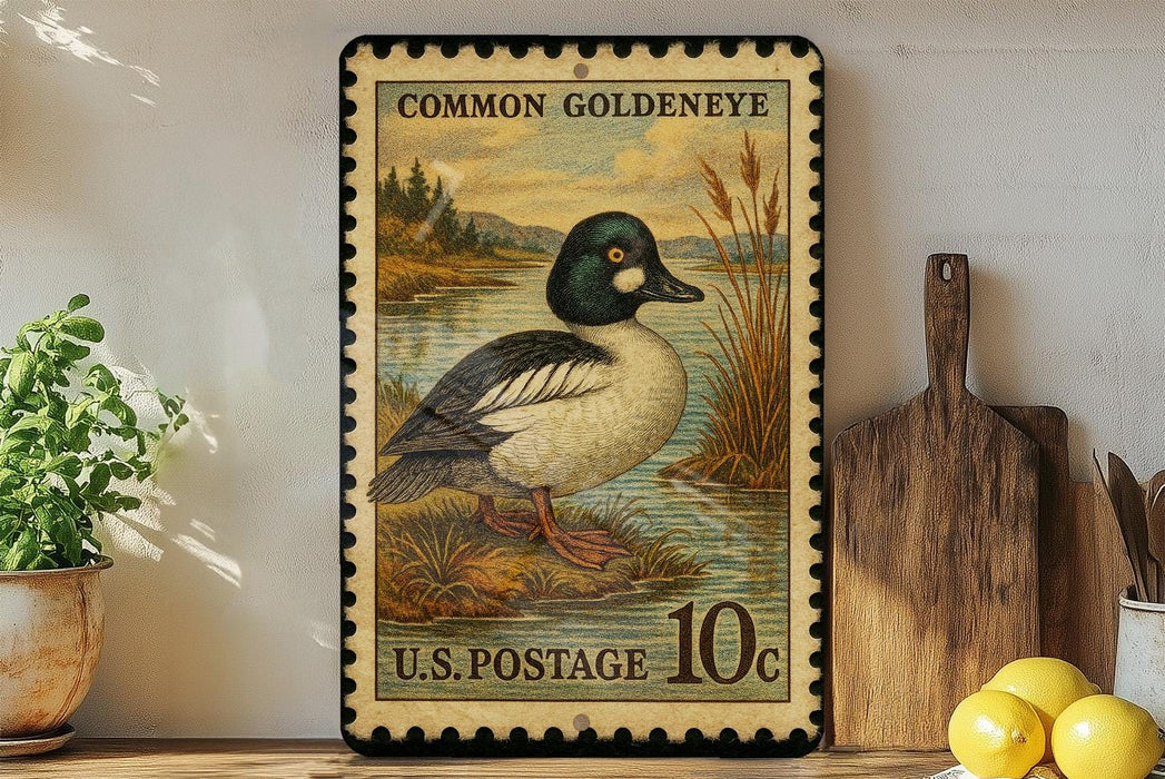 A vintage-style postage stamp depicting a Common Goldeneye duck, with a price of 10 cents, is displayed on a wooden surface next to a wooden cutting board and some lemons.