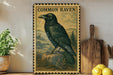 a framed illustration of a black raven perched on a rock, surrounded by a natural landscape.