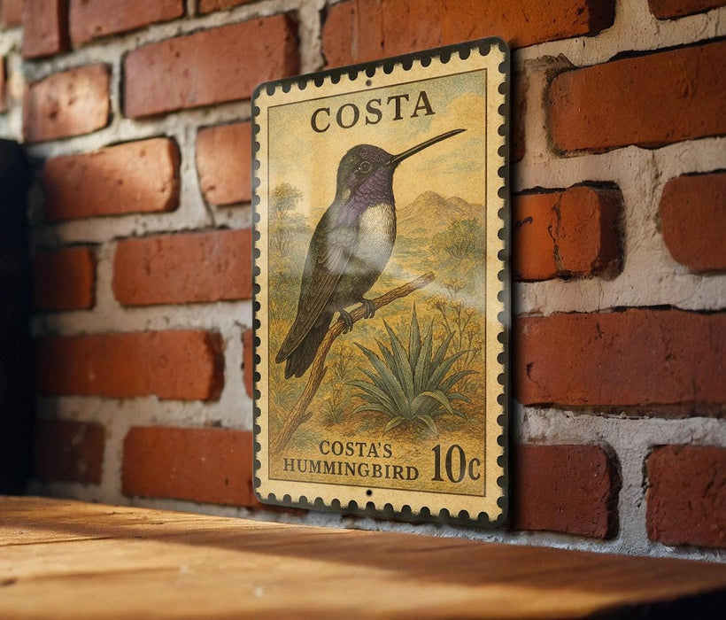 A vintage postage stamp featuring a hummingbird is displayed on a brick wall.