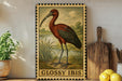 A framed illustration of a red heron is displayed on a shelf, surrounded by kitchen utensils and a potted plant.