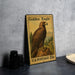 A framed postage stamp featuring a golden eagle, a symbol of the United States Postal Service.