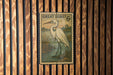 A postage stamp featuring a great egret standing in a pond, mounted on a wooden wall.