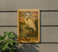 a sign with a picture of a great white heron, mounted on a wall.