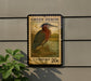 A postage stamp featuring a heron is displayed on a wall, with a plant to the left.