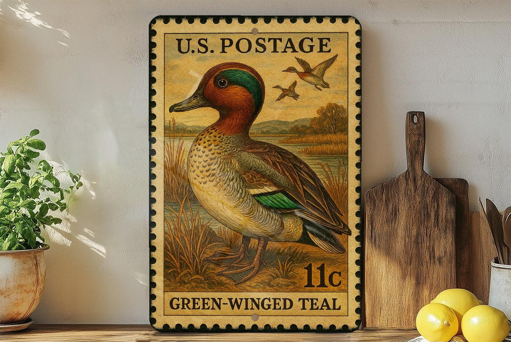 A vintage U.S. postage stamp featuring a green-winged teal duck, displayed on a wooden shelf next to a wooden cutting board and some lemons.