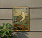 a postage stamp-like sign with a seagull illustration, mounted on a wall next to a plant.