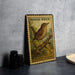 A vintage-style postage stamp featuring a house wren, a small bird, is displayed on a table.