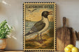 a framed illustration of a laughing gull, a bird commonly found near coastal areas, standing on a beach with a backdrop of the ocean.