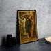 A framed illustration of a woodpecker is displayed on a wall, with a stack of black camera lenses and a white dish visible to the side.