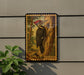 A framed illustration of a woodpecker is mounted on a wall, with a plant to the left of the frame.